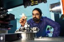 Sina Shahbazmohamadi places a 3-D printed copy of a recorder foot joint into a measuring device in a lab at the University of Connecticut's Center for Clean Energy Engineering.