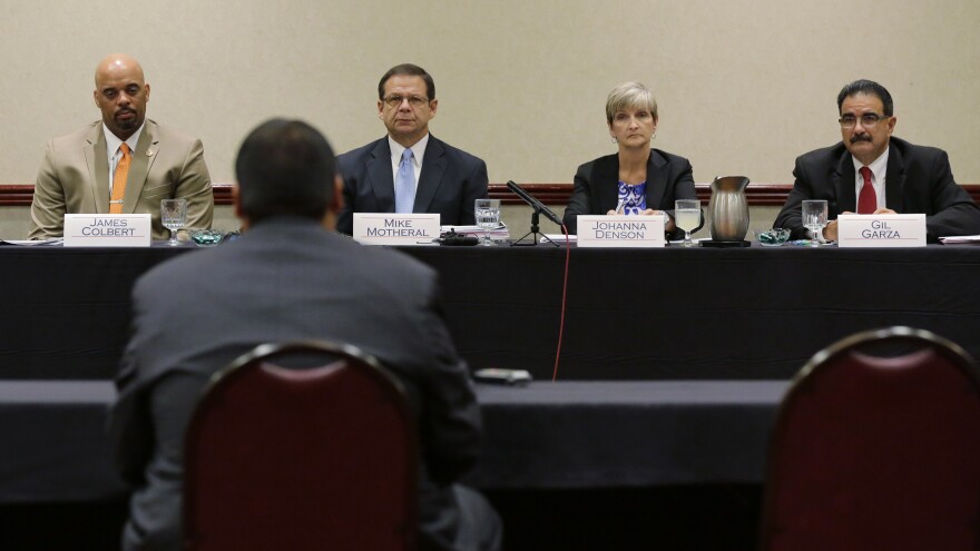 John Jay High School head football coach Gary Gutierrez testifies before the University Interscholastic League State Executive Committee Thursday in Round Rock, Texas. The school's principal and Gutierrez told the UIL that they believe assistant coach Mack Breed told players to retaliate against an official in the closing minutes of a game earlier this month.