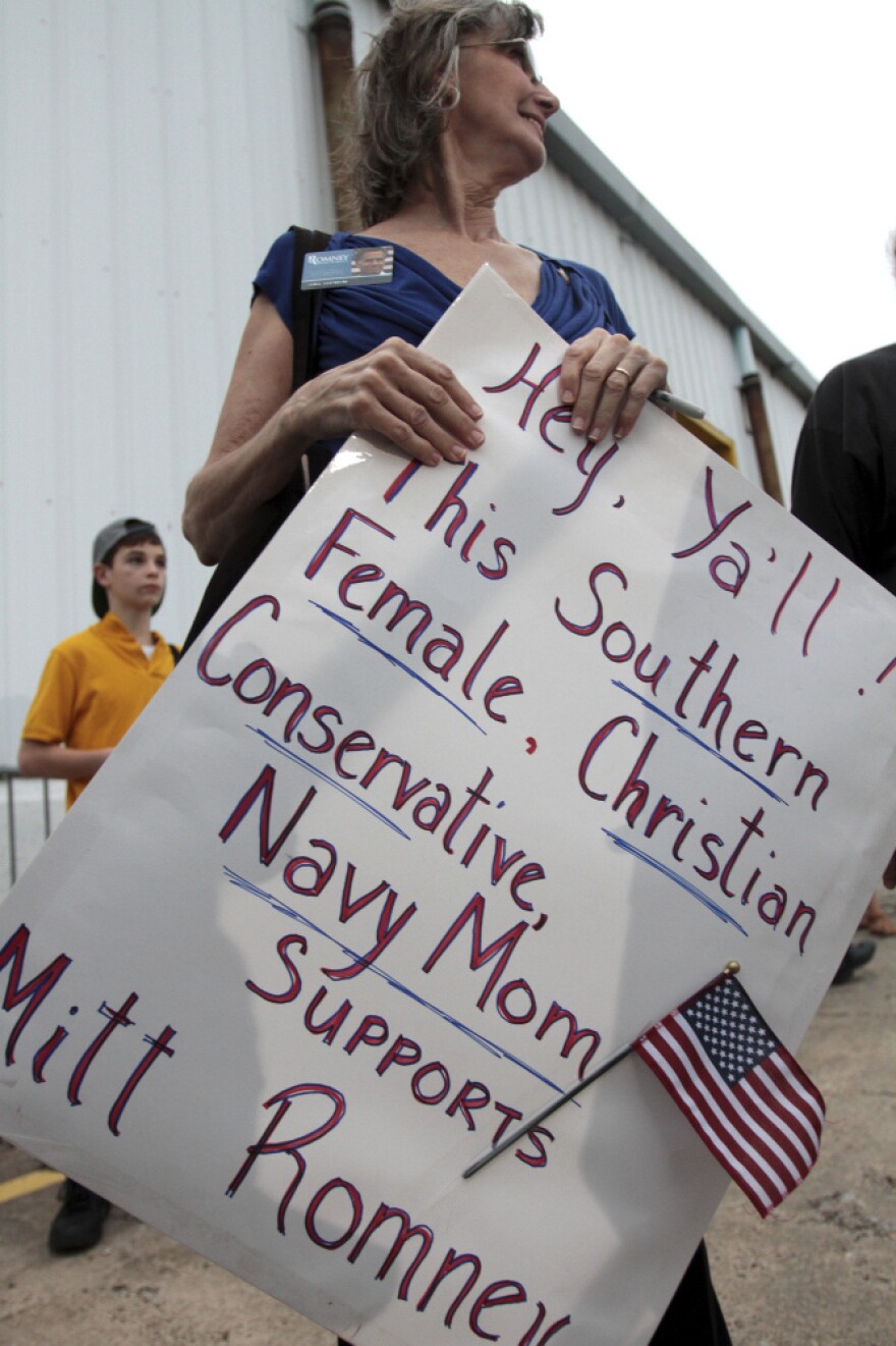 Carla Castorina of Hurley, Miss., holds a sign supporting former Massachusetts Gov. Mitt Romney after a campaign rally at the Port of Pascagoula in Pascagoula, Miss., on March 8. Polls show a tight race in the state, which holds its primary on Tuesday.