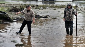 Miranda Woodard and Joey Schendel salvage and clean property after days of flooding in Hygiene, Colo. Mountain towns that had been cut off for days by massive flooding slowly reopened Monday, to reveal cabins toppled, homes ripped from their foundations and everything covered in a thick layer of muck.