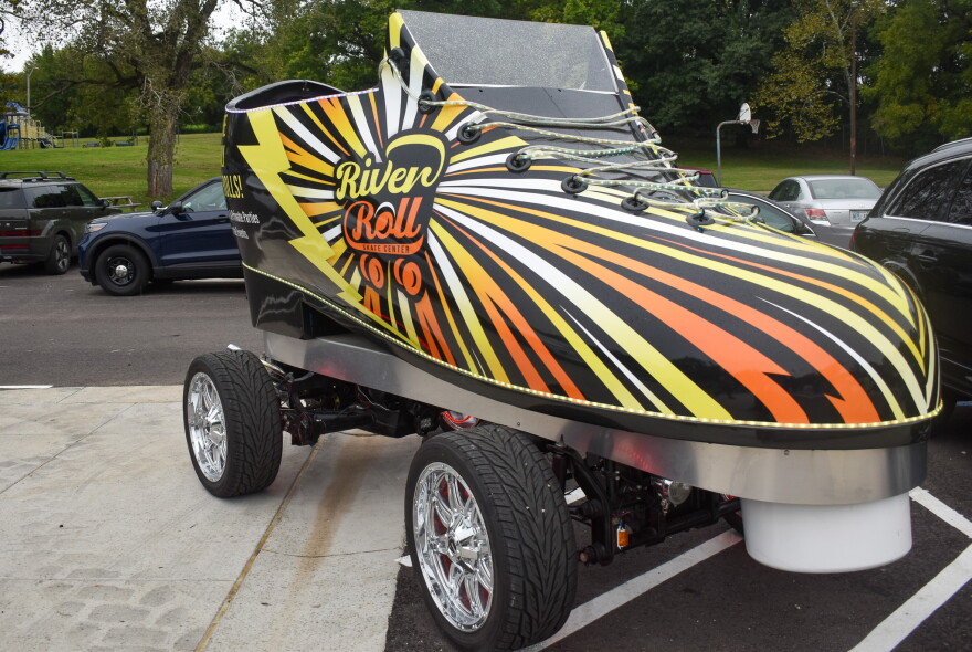 A giant replica of a roller skating shoe is parked.