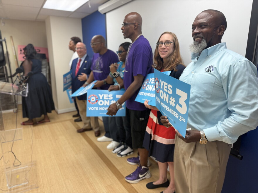 Kelvin Manurs, right, joins with Senator Elizabeth Bennett-Parker and other supporters of Amendment 3 at a press conference in Alexandria Tuesday.