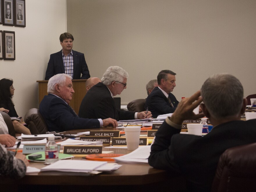 Members of the Arkansas State Plant Board listen to a presentation by Monsanto executive Ty Vaughn (standing) in September 2017.