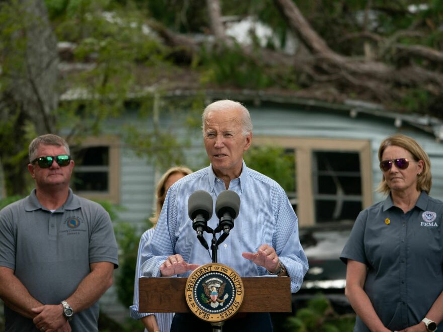 President Biden speaks in front of a home destroyed by fallen trees and debris during a tour of communities impacted by Hurricane Idalia, in Live Oak, Fla., on Saturday.
