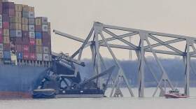 A container ship rests against wreckage of the Francis Scott Key Bridge. (Matt Rourke/AP)