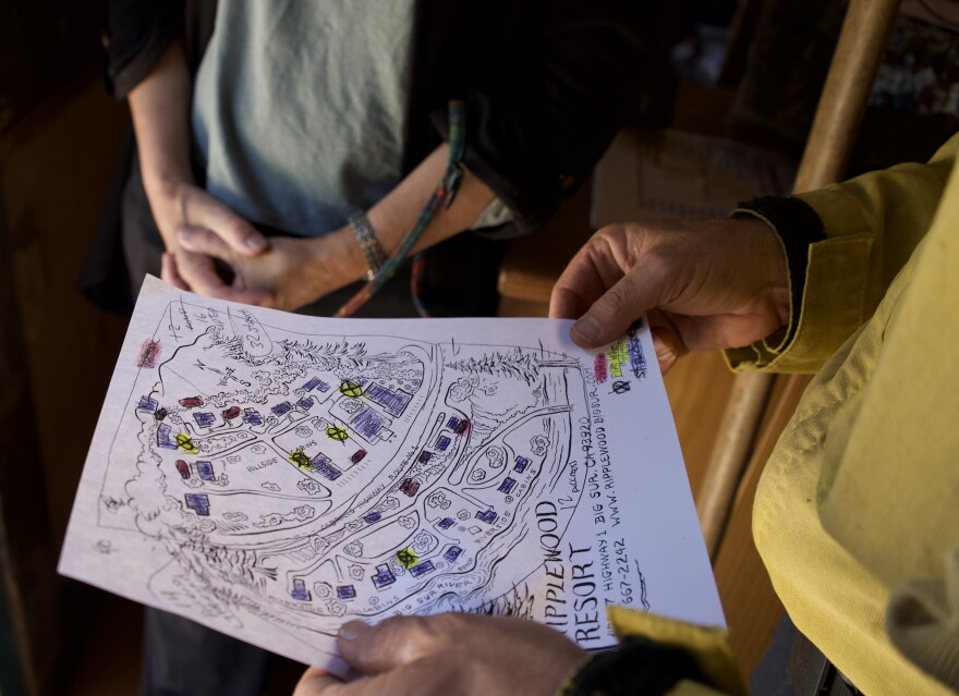 A map with highlighted landmarks is held in someone's hands. 