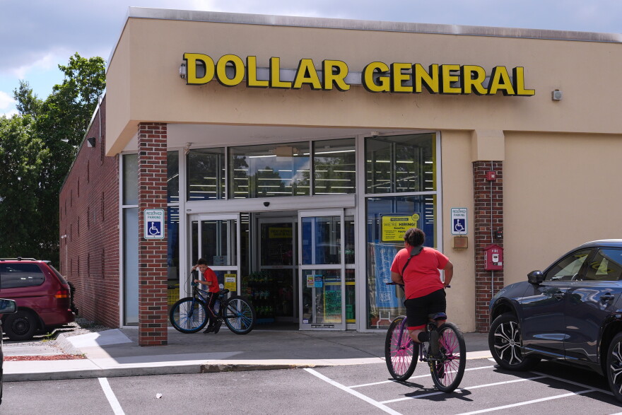 FILE - Children ride their bicycles to the Dollar General store, Aug. 21, 2025, in Nashua, N.H. (AP Photo/Charles Krupa, File)