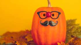Halloween pumpkin wearing glasses and mustache