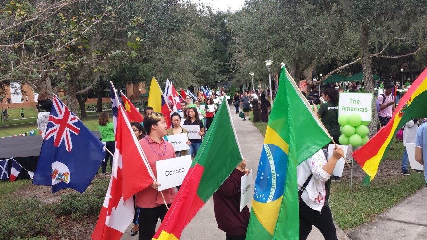 USF students show their native flags at the International Festival in November 2015. USF is bringing some students studying abroad home early from countries like South Korea and Italy due to concerns about the coronavirus.