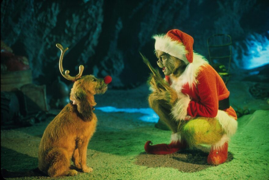 The Grinch, played by Jim Carrey, conspires with his dog Max to deprive the Whos of their favorite holiday in the live-action adaptation "Dr. Seuss' How The Grinch Stole Christmas." (Getty Images)