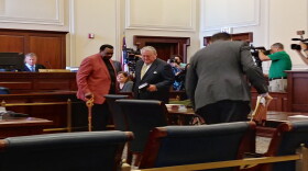 Wendell Young, (center left), and his attorney Scott Croswell, (center right) prepare to leave the courtroom Thursday morning.