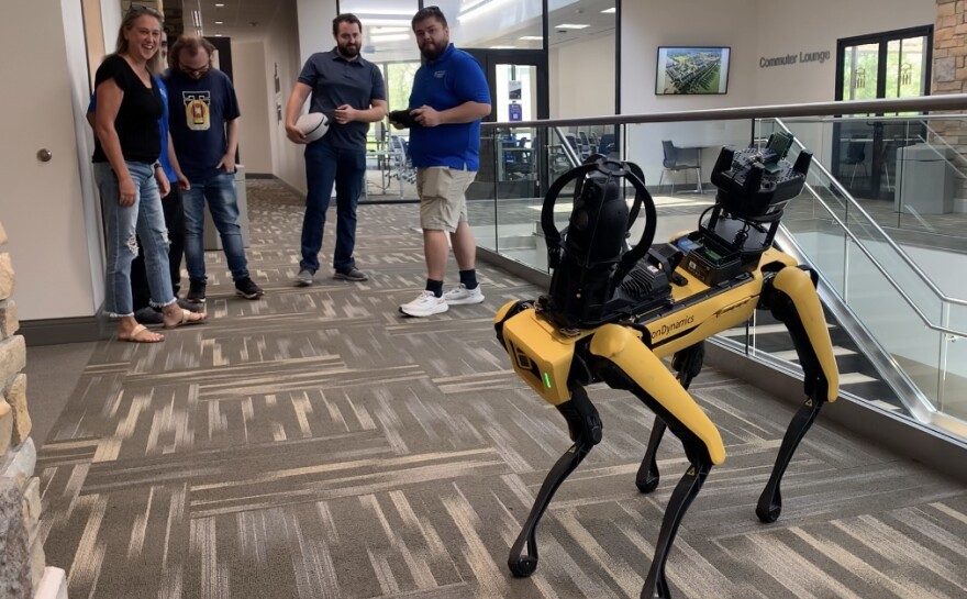 University of Tulsa graduate students control a robot that functions like a dog on Tuesday, Aug. 13, 2024, at an event for Tulsa Public Schools librarians on the college campus.