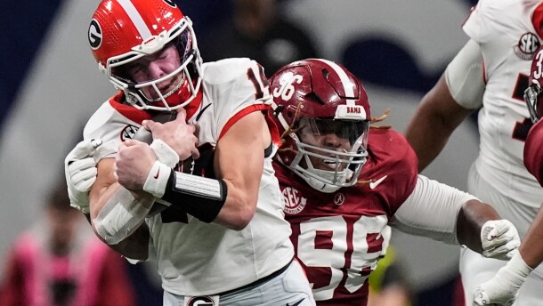 FILE - Georgia quarterback Gunner Stockton (14) runs against Alabama during the second half of a Southeastern Conference championship NCAA college football game in Atlanta, Dec. 6, 2025. (AP Photo/Mike Stewart, File)