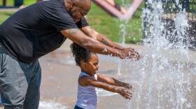 Curtis Thompson plays with his son Na'ki Walker, 2, of Wilkes-Barre, at the Dr. Martin Luther King Jr. Park in Wilkes-Barre.