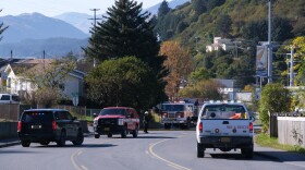 Emergency vehicles stopped on Mill Bay Road during the closure while crews worked on the fire.