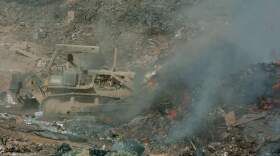 In a 2004 photo, Army Sgt. Richard Ganske uses a bulldozer to maneuver trash into a burn pit in Balad, Iraq. Burn pits were common at U.S. military outposts in Iraq and Afghanistan, where troops incinerated tons of waste every day. (Abel Trevino/U.S. Army)