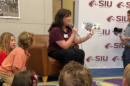 Children listen to the new "SIU A to Z" book published by the SIU Alumni Association