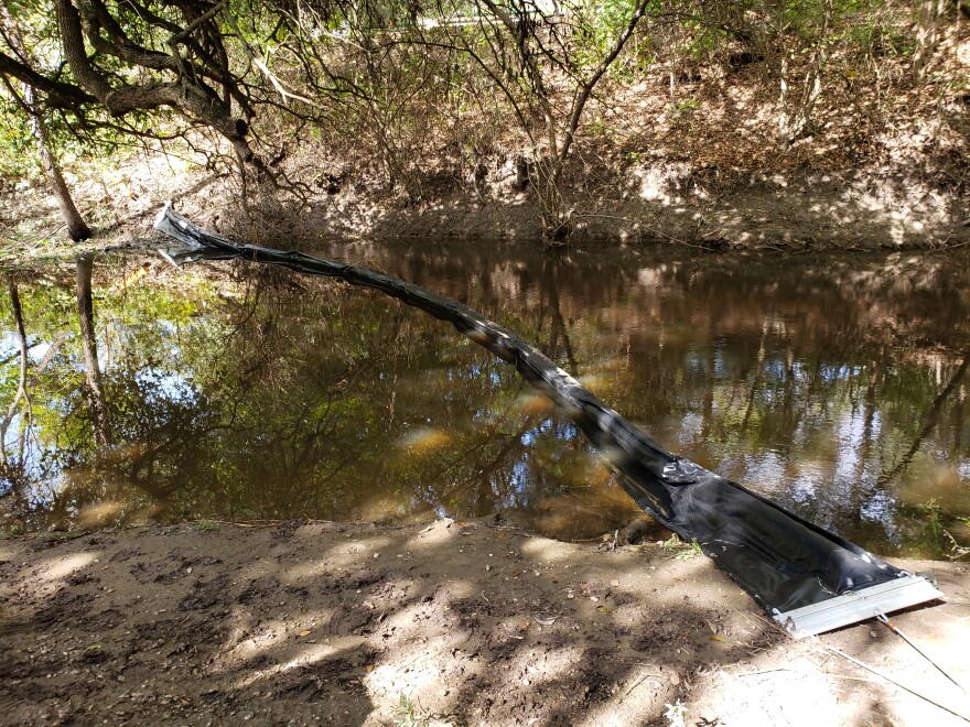Litter boom on Salado Creek at Comanche Park will capture trash before it can float further downstream