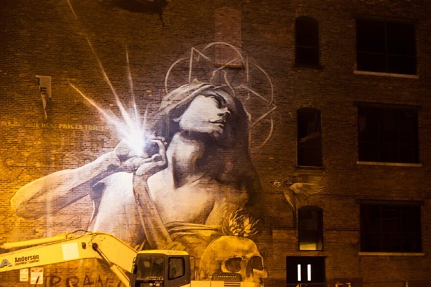 South African artist Faith47 paints "Rhapsody" on the Lofts at Michaels-Stern on Pleasant Street in 2021.