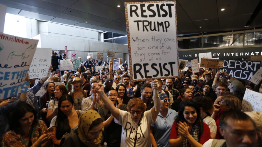 Hundreds of people protest President Trump's travel ban at LAX airport Sunday in Los Angeles.
