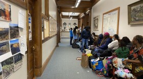 Families wait inside Sanford city hall on Monday for an appointment with the General Assistance office. City officials say Sanford is "overwhelmed" trying to meet demand.