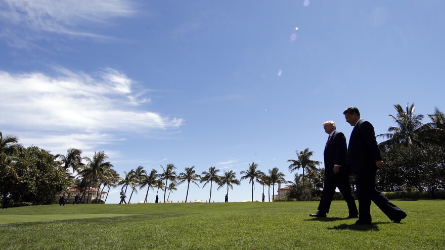 Trump and Chinese President Xi Jinping walk together after their meetings at Mar-a-Lago on April 7, 2017, in Palm Beach, Fla.