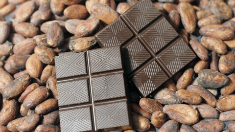 Finished dark chocolate is shown atop cacao beans at the new TCHO chocolate factory in San Francisco, Calif., Monday, Aug. 25, 2008.(AP Photo/Eric Risberg)