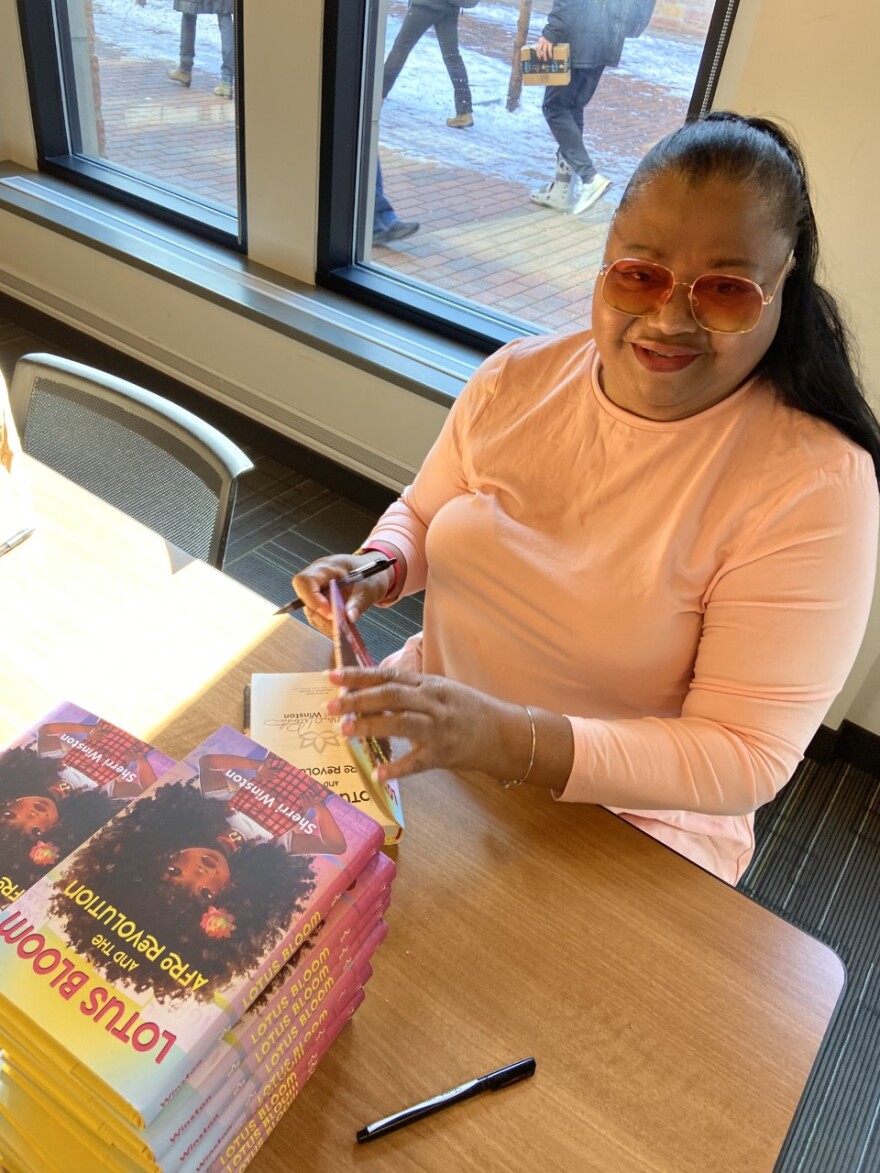 Sherri Winston signs copies of her book, "Lotus Bloom and the Afro Revolution" at the University of Colorado at Boulder, Nov. 4 , 2022.