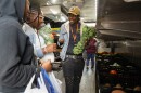Shemaiah Pressley, with Foodlink, shows off a brussels sprout stalk to Fallon Brooks and Malaysia Brown at Foodlink’s Mobile Curbside Market, parked outside the Hall of Justice on Monday, September 20, 2025. The Curbside Market brings fresh, affordable food to neighborhoods across the Rochester area, helping families access healthy food close to home.