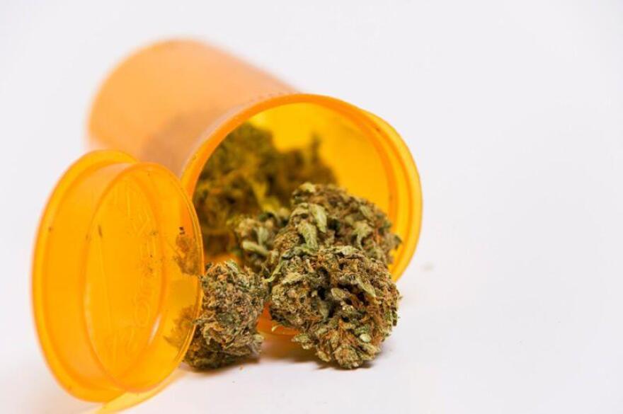 A yellow plastic pill bottle of medical marijuana