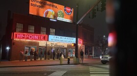 A picture of the neon-lit Hi-Pointe theater on a rainy, foggy night. 