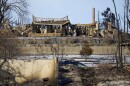 The burned remains of a home destroyed by the Marshall Fire are shown Friday, Jan. 7, 2022, in Louisville, Colo. (AP Photo/Jack Dempsey)