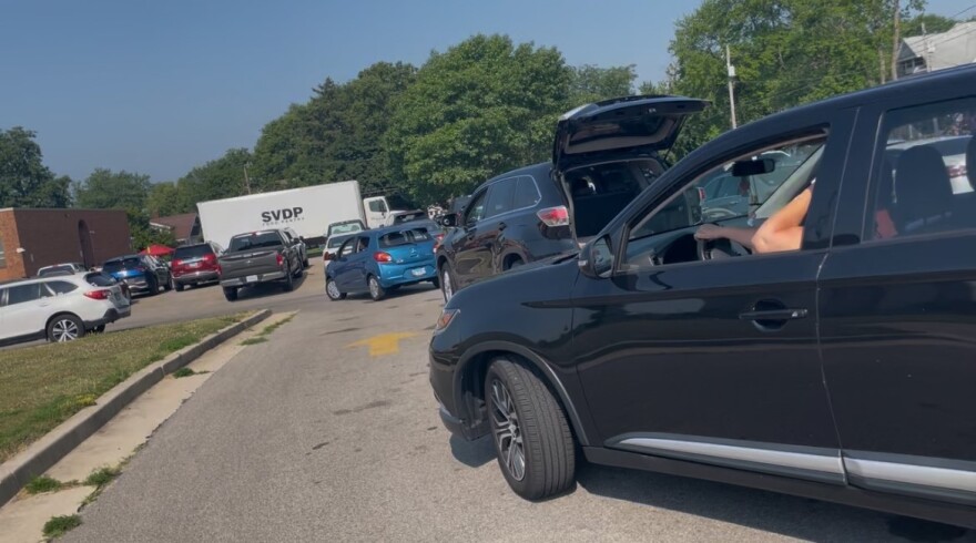 Clients wait in their cars for food distribution at St. Vincent de Paul Food Pantry