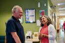 Sen. Tim Kaine speaks with Sinclair Health Clinic's executive director, Dr. Mercedes Abbet, in Winchester on Monday.