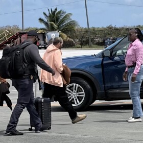 Pictured: Mohammad Suid is escorted by detectives after arriving on a Delta flight to St. Croix on Friday, March 27, where he was taken into custody in connection with a worthless check investigation.