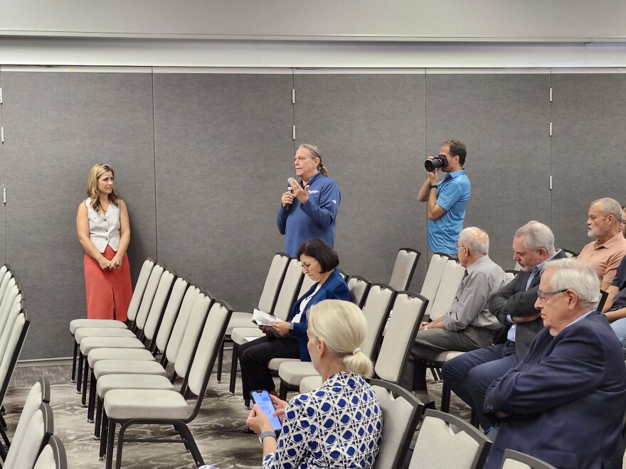 Man talks among audience.