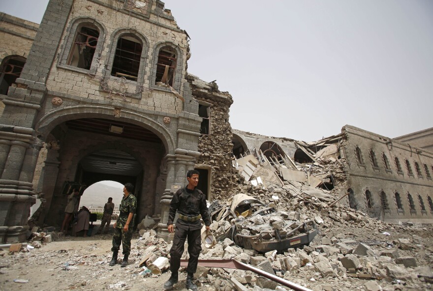 Houthi fighters stand guard in front of Yemen's Defense Ministry building in the capital Sanaa on Wednesday after it was damaged by Saudi-led airstrikes. The Houthis seized control of the capital late last year. Saudi Arabia has been bombing the Houthis since March.