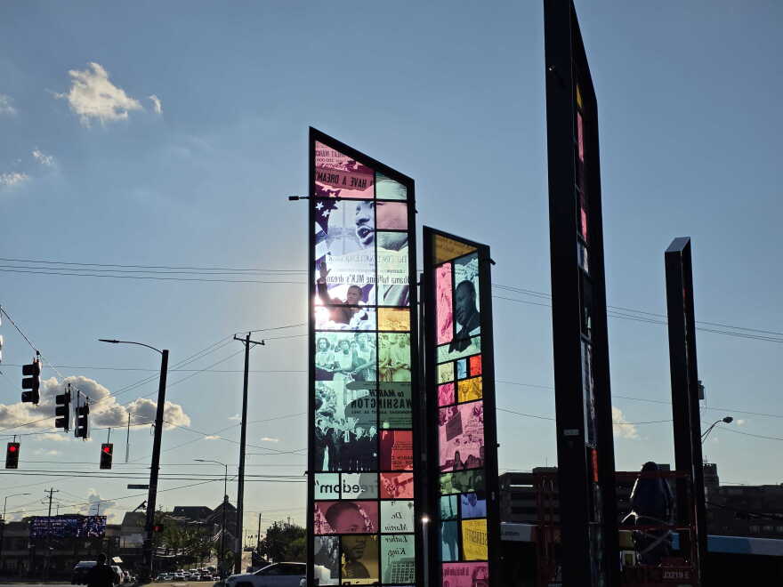 Stained glass panels of photos and newspaper headlines of Martin Luther King Jr.