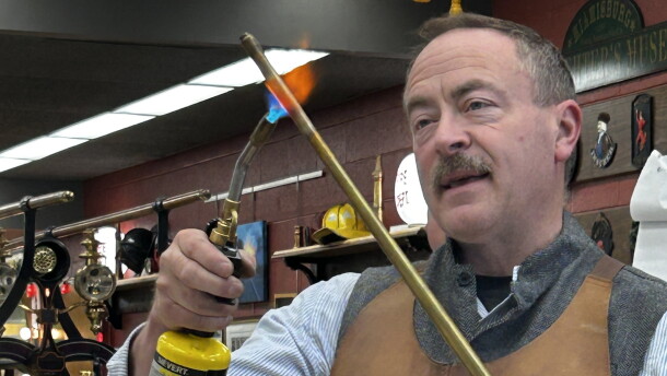 Pictured here is custom instrument maker George Schlub demonstrates the annealing process he uses in crafting his instruments.