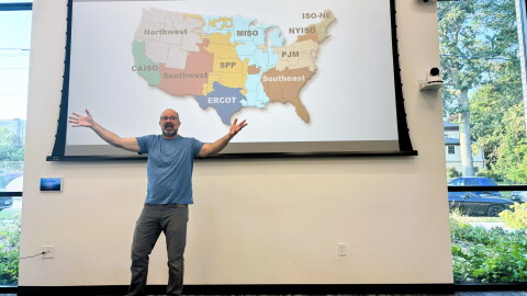 Nick Hylla, executive director of the Midwest Renewable Energy Association, explains why the cost of electricity has soared in the past five years during a presentation at the Bloomington Public Library.