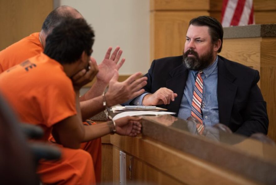 Kevin Finlay, an attorney for the Oklahoma Indigent Defense System, speaks to defendants in a Cleveland County courtroom in September. The inmate Finlay is advising wanted to ensure his sentences would be served concurrently before agreeing to any terms.