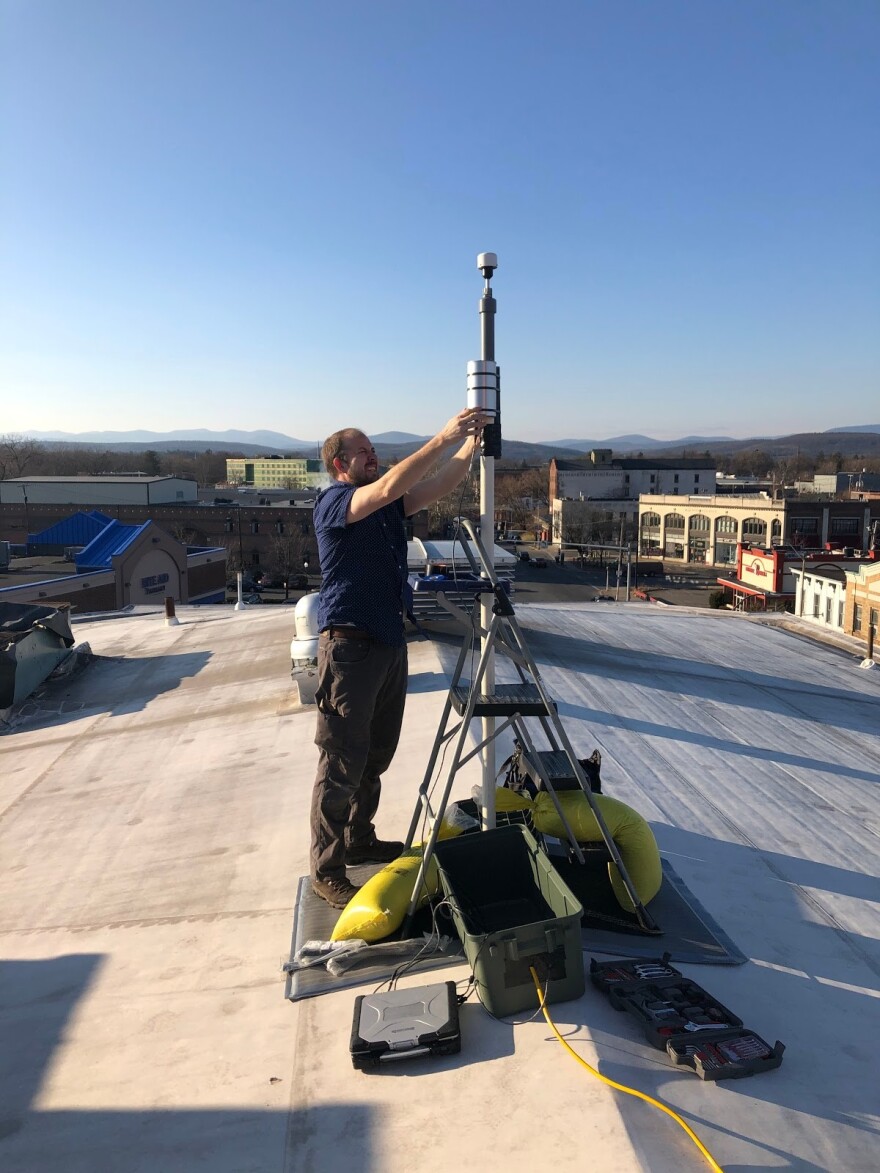 Bard College Center for the Study of Land, Air and Water Director Dr. Eli Dueker installing the MetOne 212-2 particle profiler atop the Andy Murphy Neighborhood Center in Midtown Kingston.