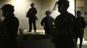 Phoenix Police stand in front of police headquarters on May 30, 2020, in Phoenix, waiting for protesters marching to protest the death of George Floyd.