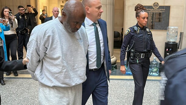 Andrew Dykes, left, is led to the courtroom by law enforcement personnel at Nassau County court in Mineola, N.Y., Thursday, Dec. 18, 2025, on charges for the 1997 killing of a young mother and her daughter that had long been tied to an infamous string of killings on Long Island known as the Gilgo Beach murders. (AP Photo/Phil Marcelo)