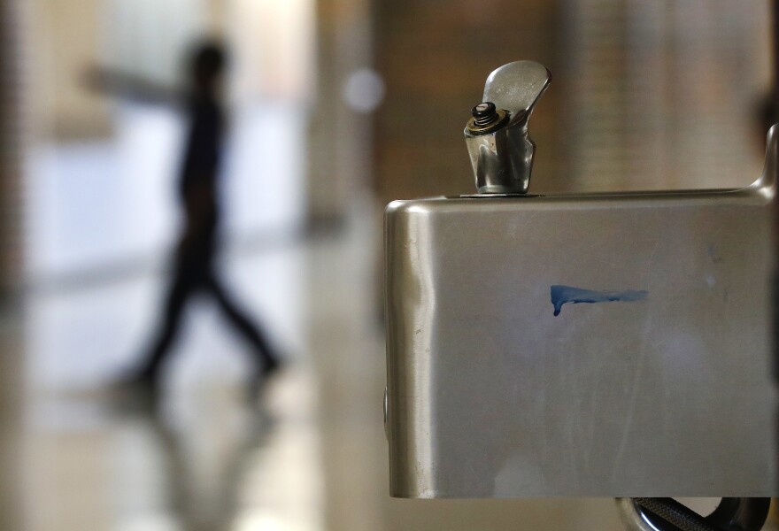 A student walks in the hallway past a water fountain at Noble School in Detroit, Tuesday, Sept. 4, 2018.