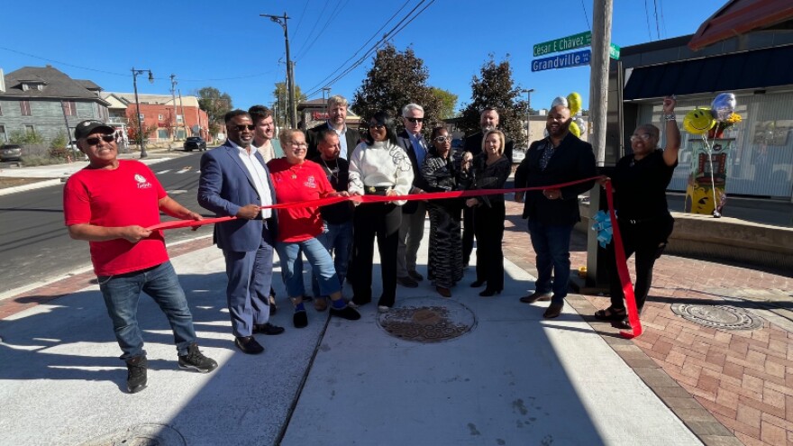 Community members, leaders, and stakeholders cut the ribbon on the reopened Cesar E. Chavez Avenue.