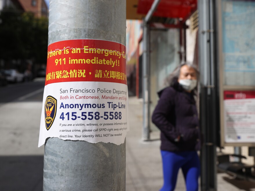 A sign posted in San Francisco's Chinatown neighborhood on March 8 encourages people to call a police tip line if they witness a crime.