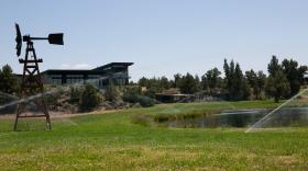 Sprinklers keep the grass green in the landscaping surrounding a pond and a pool at a property in Central Oregon