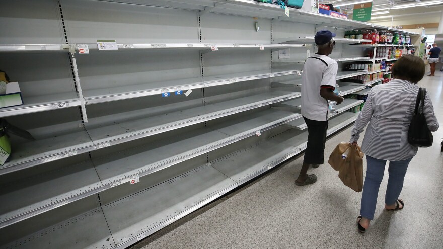 Shelves that once held bottled water are empty as Miami prepares for the approaching Hurricane Irma.