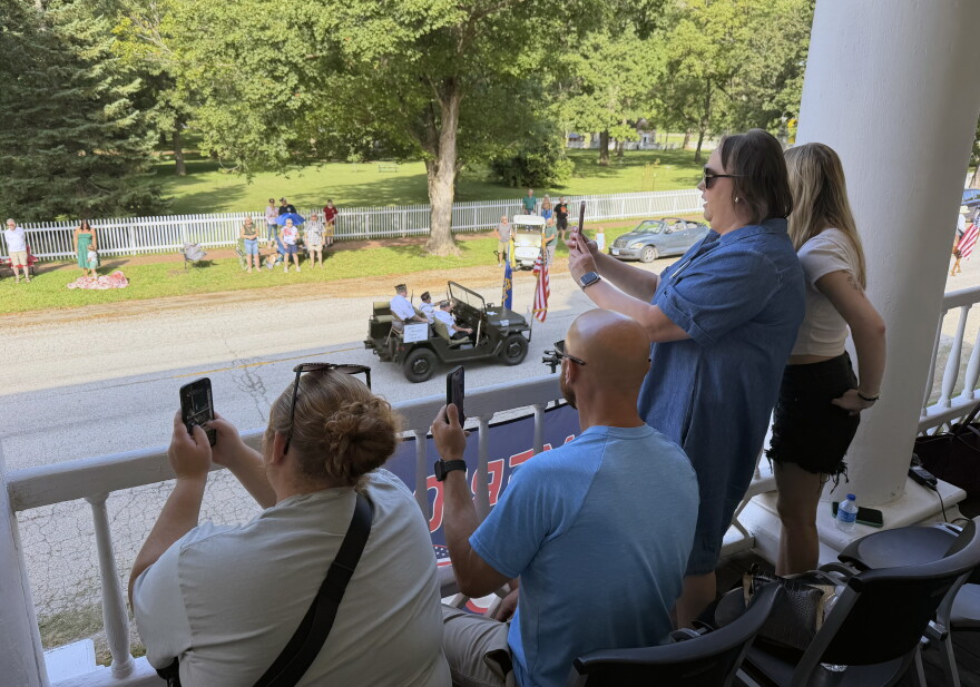 Tanya Edgil, second from right, watches the parade with her family on the balcony of the Steeple Building in Bishop Hill.